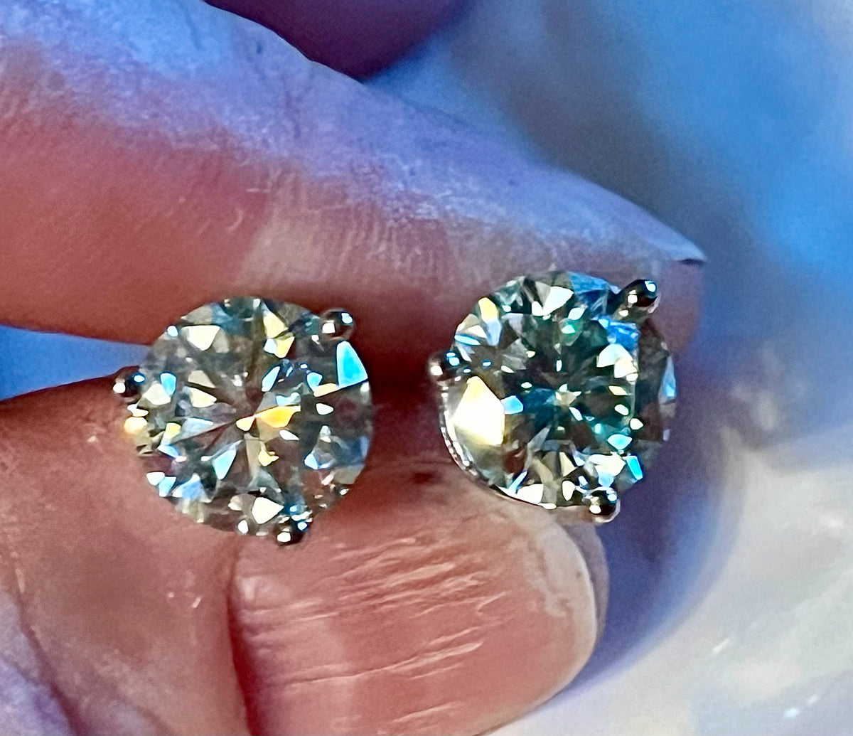 Moissanite earrings. A delicate certified 2cttw pair of 3-prong or 4-prong round brilliant Moissanites in 18k gold-embraced sterling silver baskets! Classic!