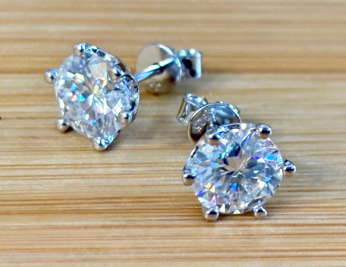 A certified pair of pretty, floral-inspired 2cttw or 4cttw Moissanite studs in poinsettia-shaped settings w/screwball backs OR 4cttw w/push backs!