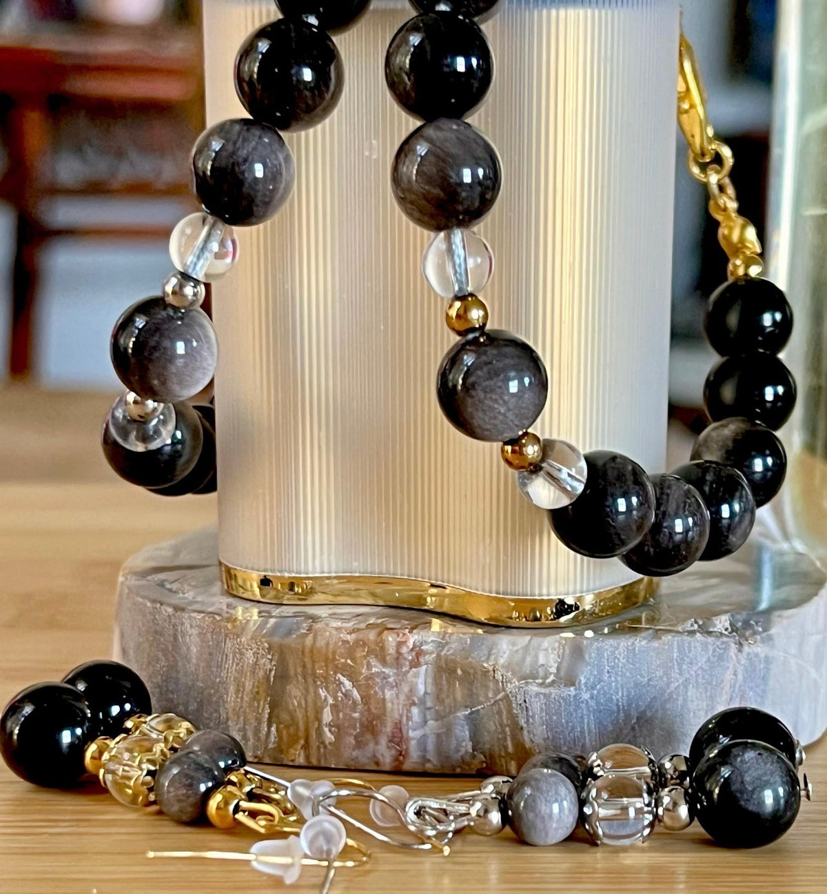 Silver sheen obsidian and clear quartz bracelet and earrings. Pair the “Silver Bells” bracelet and/or earrings with your little black party dress and be the Belle of the Ball!