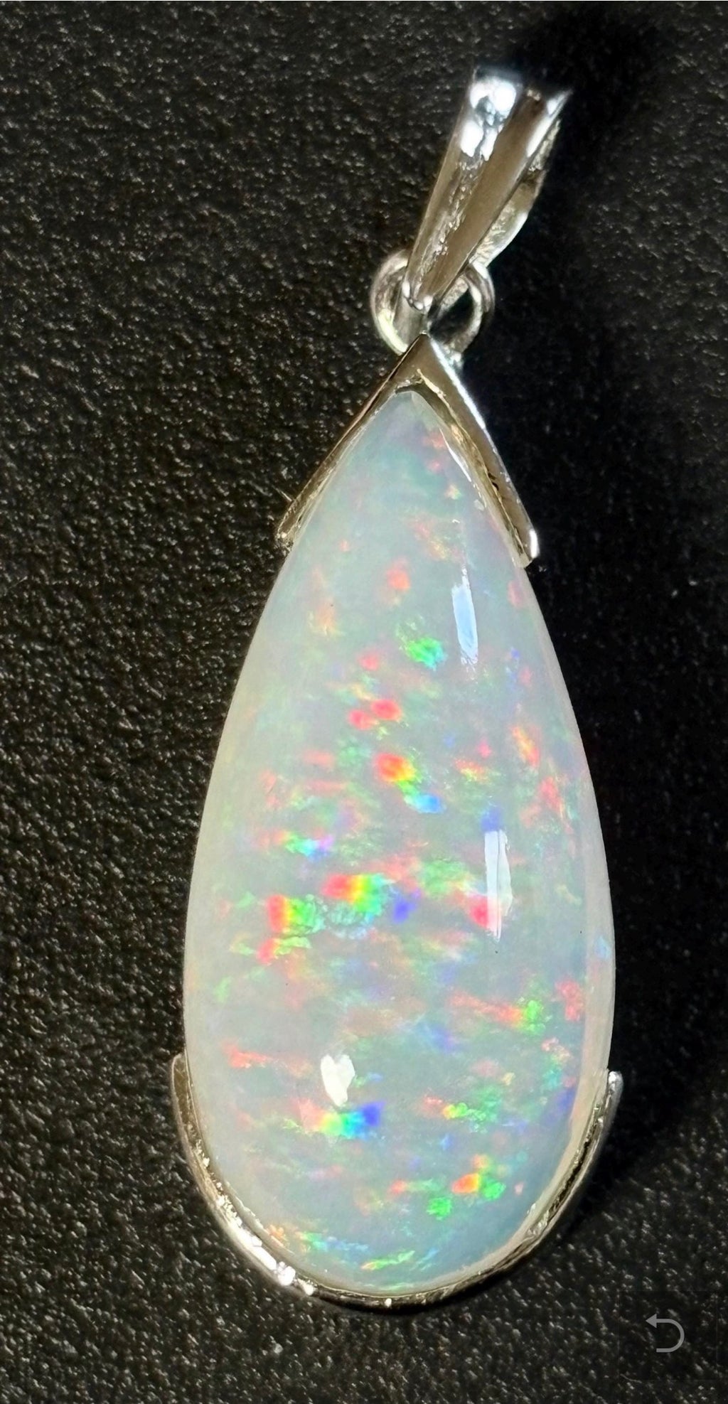 A GORGEOUS 11.05ct AAA+ grade Ethiopian pendant, an elongated pear-shaped cabochon with galaxy pattern fire and phenomenal play of color!