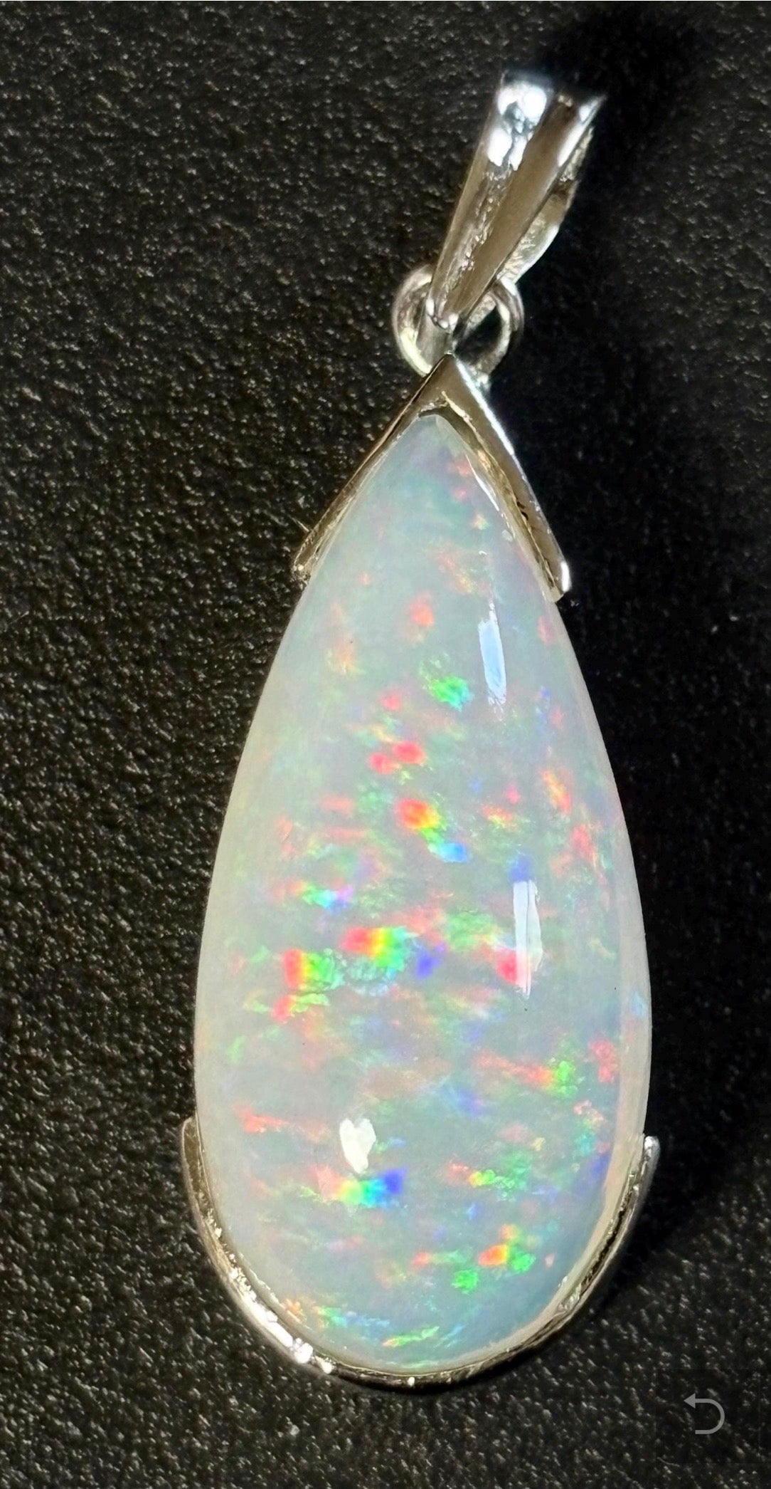 A GORGEOUS 11.05ct AAA+ grade Ethiopian pendant, an elongated pear-shaped cabochon with galaxy pattern fire and phenomenal play of color!