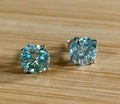 Moissanite earrings. A 6ctw certified pair of true icy baby blue Moissanite studs in sterling silver baskets with gleaming white rhodium!