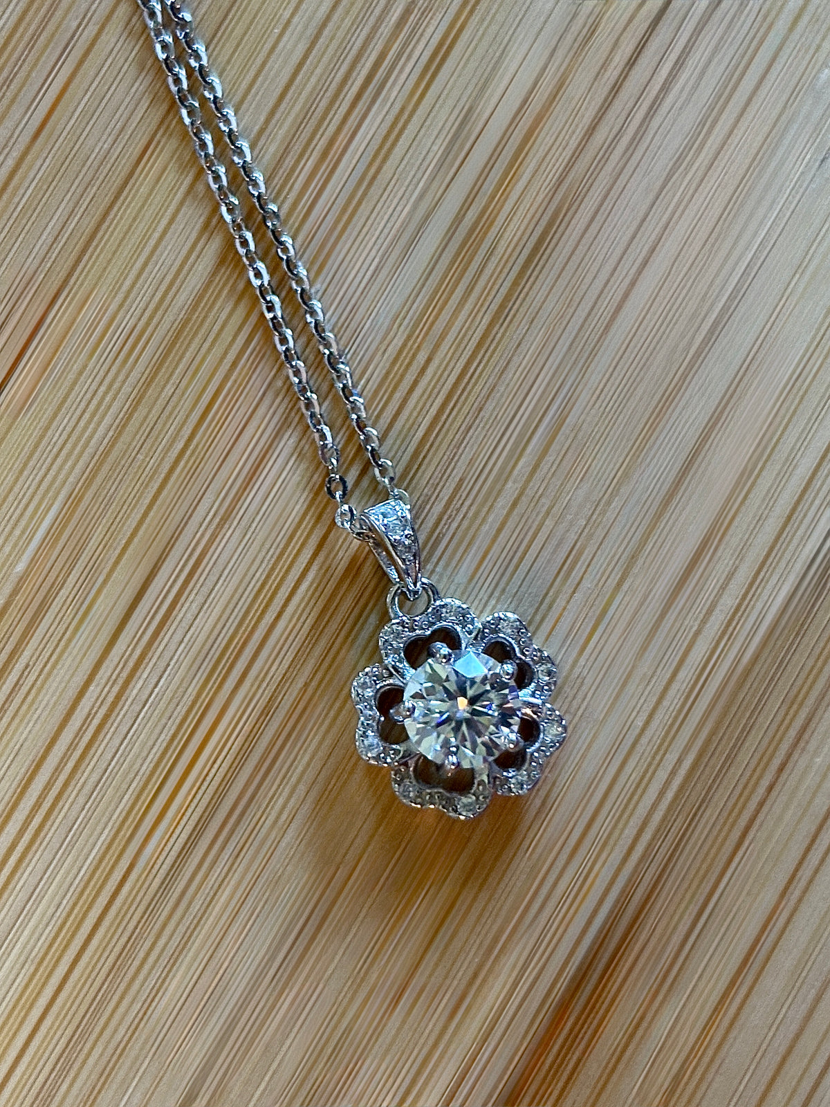 Moissanite necklace. A certified 1ct Moissanite hibiscus necklace with white zircon accents in solid sterling and white rhodium!