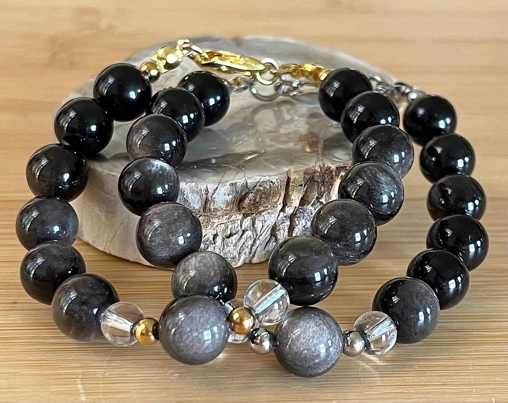 Silver sheen obsidian and clear quartz bracelet and earrings. Pair the “Silver Bells” bracelet and/or earrings with your little black party dress and be the Belle of the Ball!