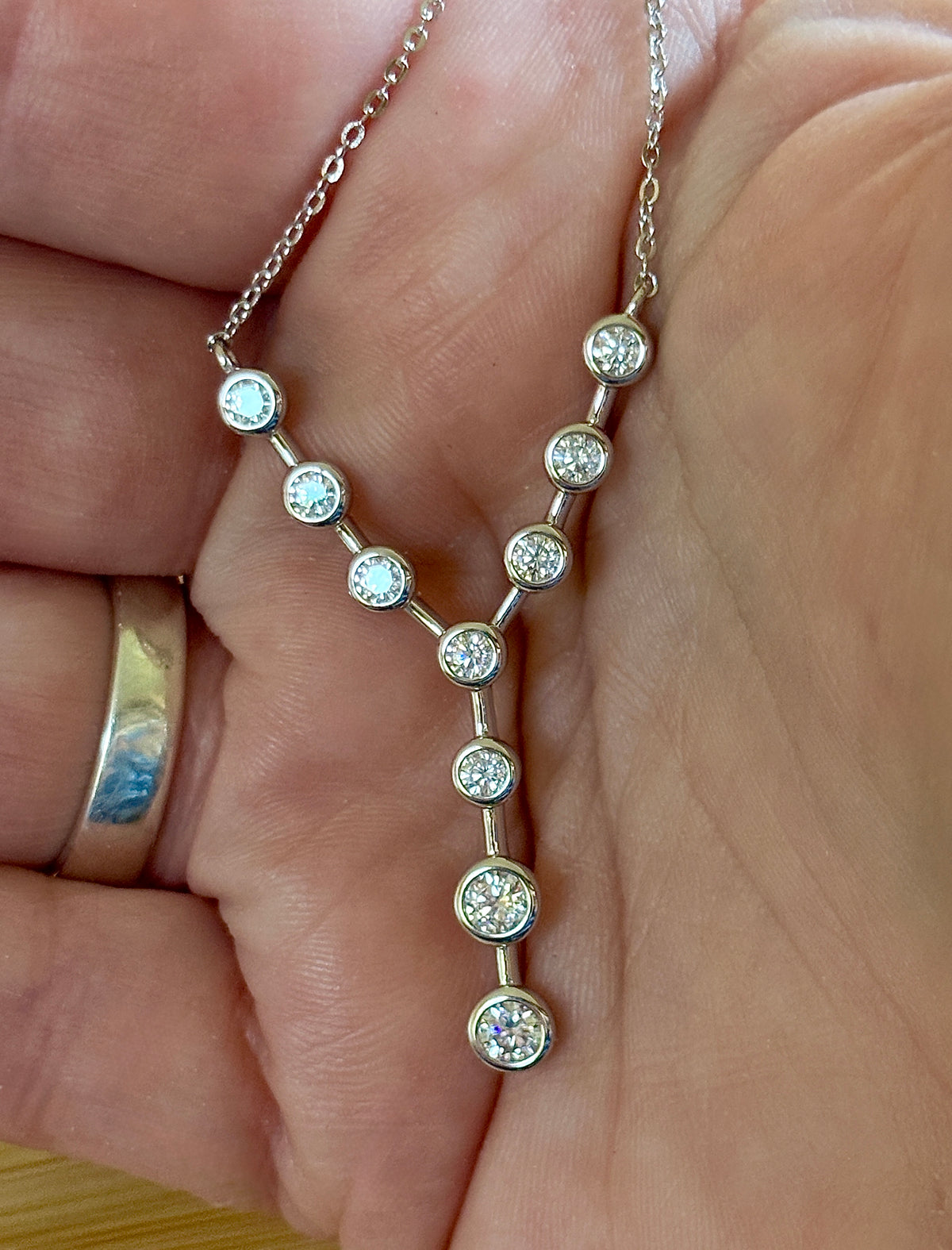 Moissanite neckpiece. A beautiful certified 1.4cttw Moissanite necklace featuring 10 round brilliants in a solid sterling bezel setting!