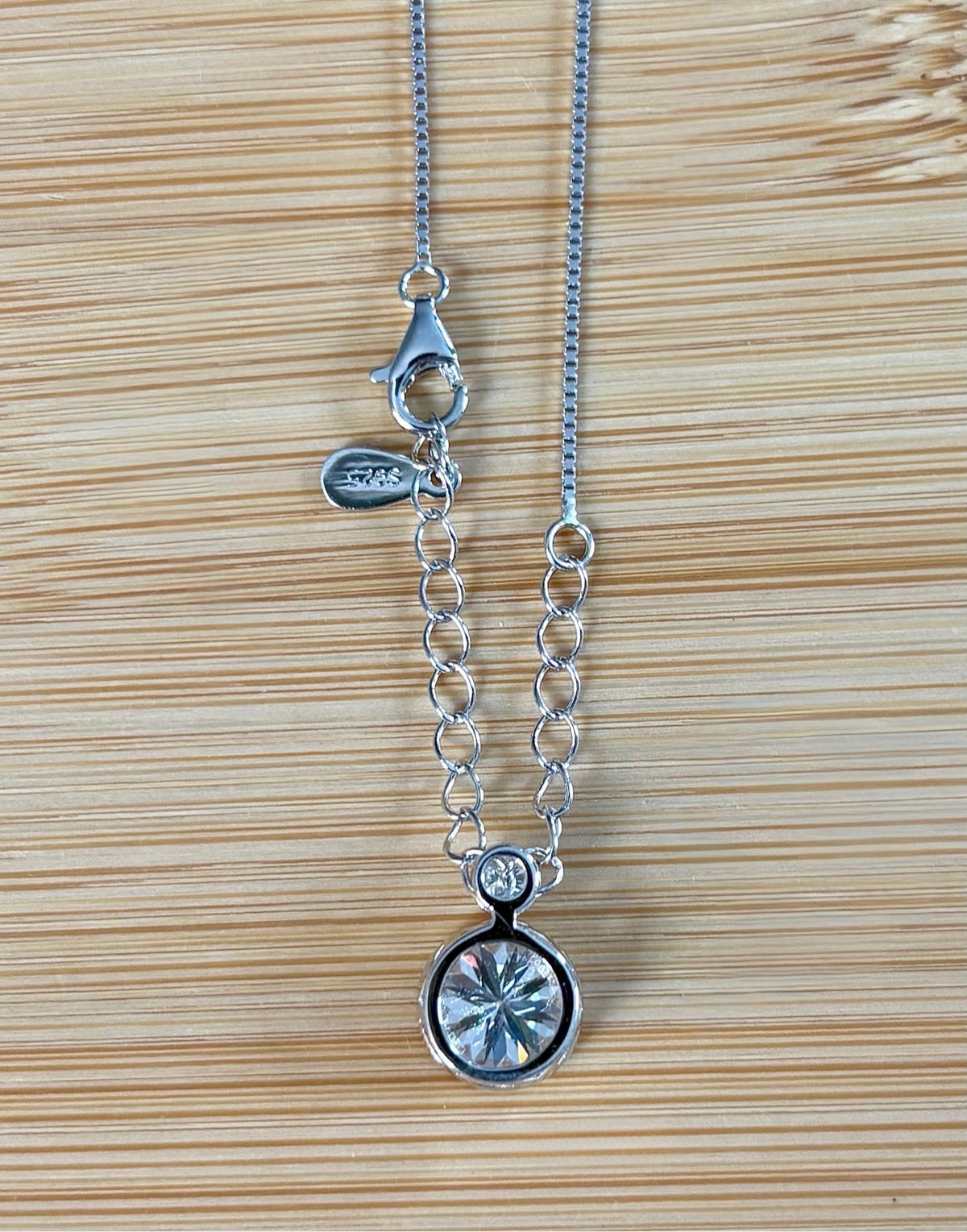 Moissanite necklace. A bright 2.1ctw certified Moissanite bezel pendant, with a 18” box chain and lobster claw clasp in sterling silver!
