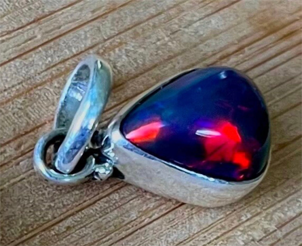 2.99ct Ethiopian opal pendant. AAA grade smoked opal cabochon pear in solid sterling silver. This flashy stone measures 9.6mm x 13mm!