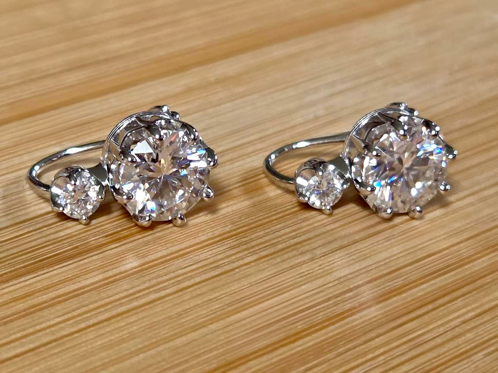 A Victorian inspired 4.2cttw certified pair of Moissanite 2-stone buckle back earrings in Argentium silver! Minimalist glam!