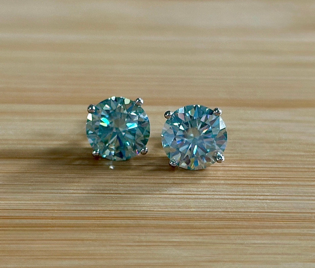 Moissanite earrings. A 6ctw certified pair of true icy baby blue Moissanite studs in sterling silver baskets with gleaming white rhodium!
