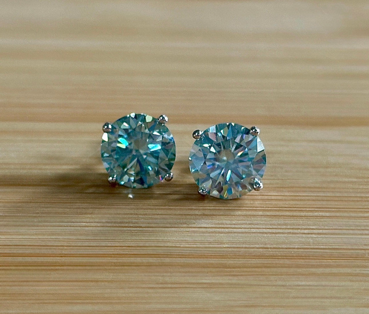 Moissanite earrings. A 6ctw certified pair of true icy baby blue Moissanite studs in sterling silver baskets with gleaming white rhodium!