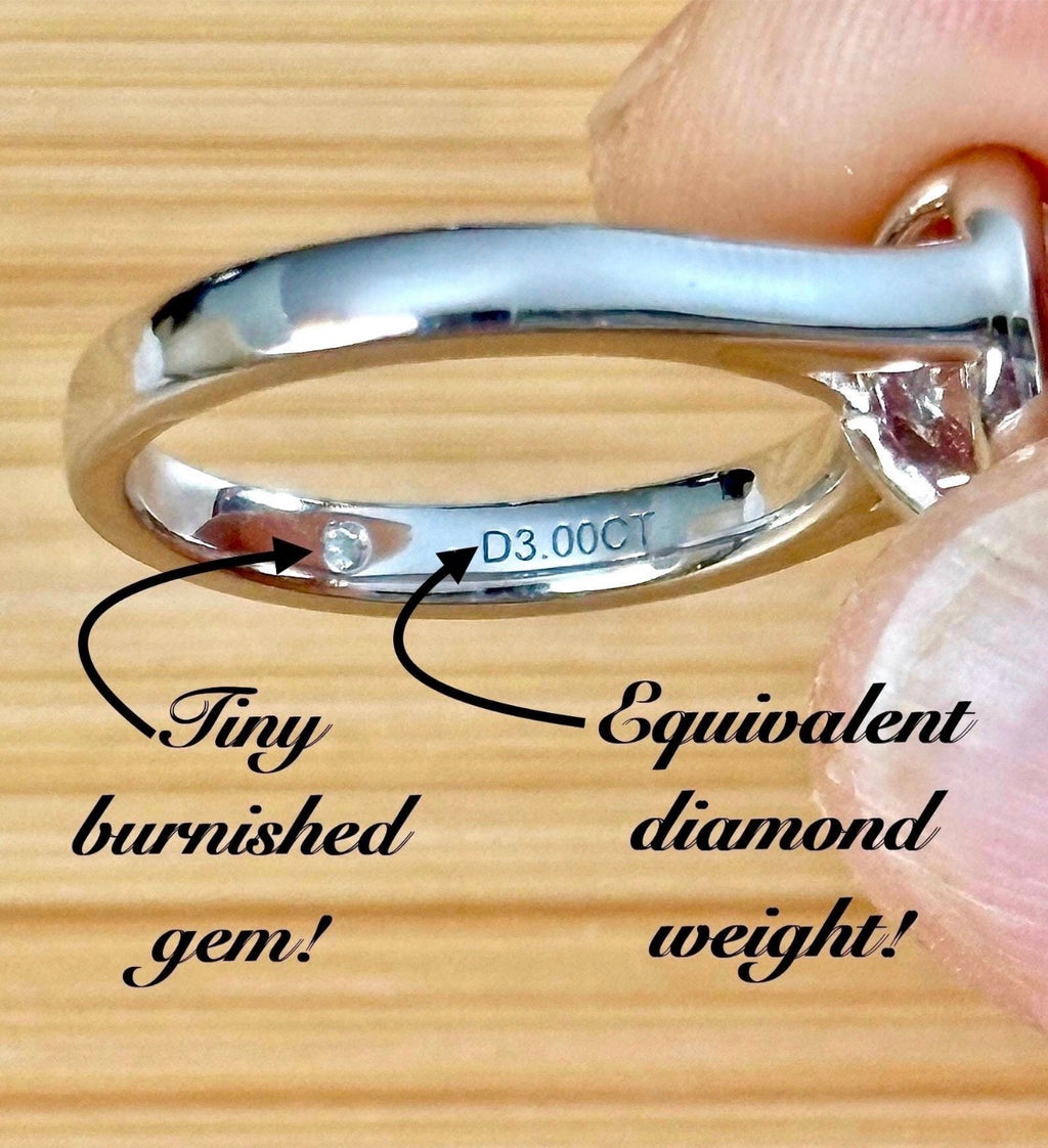 Moissanite ring. A high-end solitaire with a certified 3ct heart-cut stone, bezel-set in a heavy sterling silver mounting and bathed in 18k!