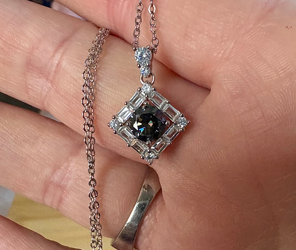 Moissanite necklace. A transfixingly gray 1ct certified round brilliant Moissanite centered in a halo of white zircons - a 2.25cttw pendant!
