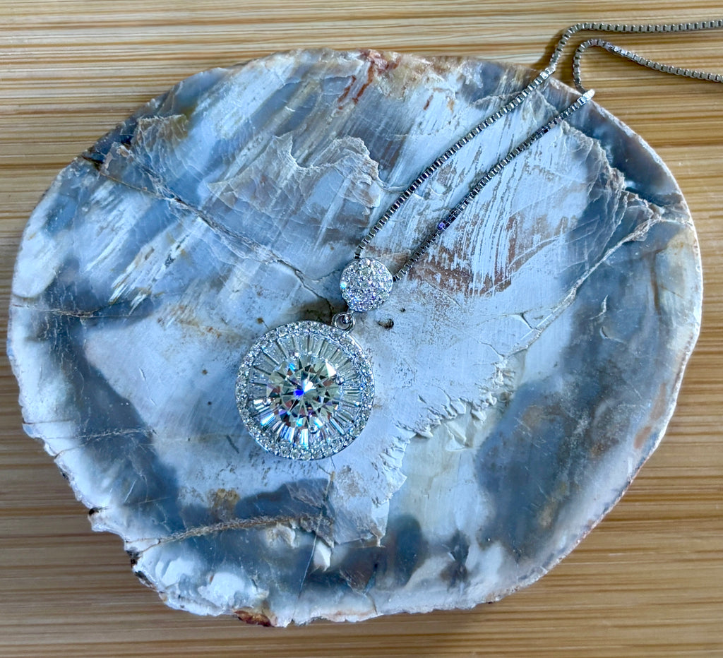 Moissanite necklace. The certified 2ct Moissanite “Sunburst” necklace with a 61 gemstone pendant plus more in the bail! Radiantly beautiful!