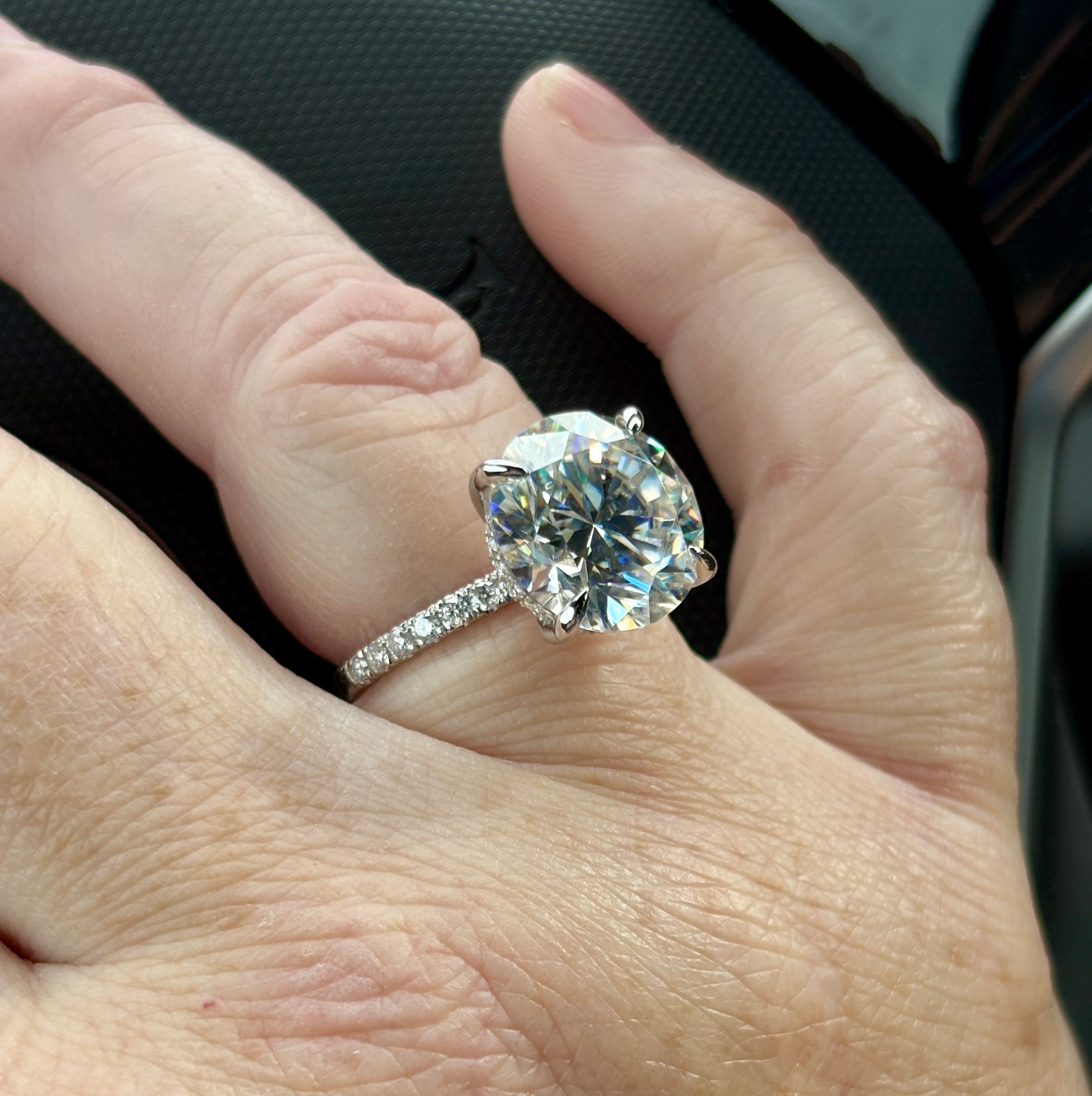 Moissanite solitaire. A glorious 10ct 8H8A Moissanite in a 4-prong mounting with a Moissanite “hidden halo” and shoulders, an 11.3cttw ring!