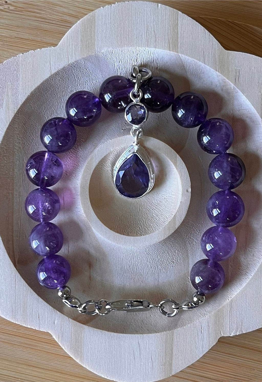 Amethyst bracelet. Natural and vibrant 10mm amethyst beads and stainless steel! The amethyst pendant in solid sterling silver is optional.