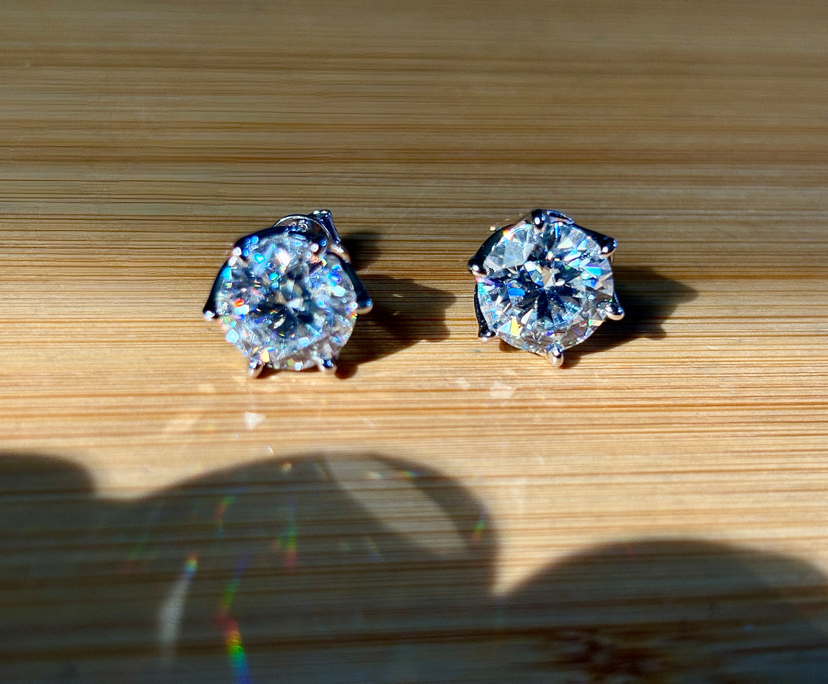 A 10ctw pair of double certified Moissanite studs in lotus-shaped sterling silver baskets!