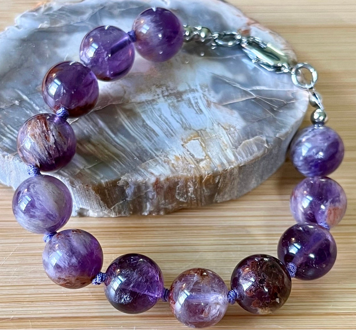 Super seven amethyst bracelet. AAA-grade 12mm “super seven”, mineral name cacoxenite amethyst, hand-knotted with silvery or golden hardware!