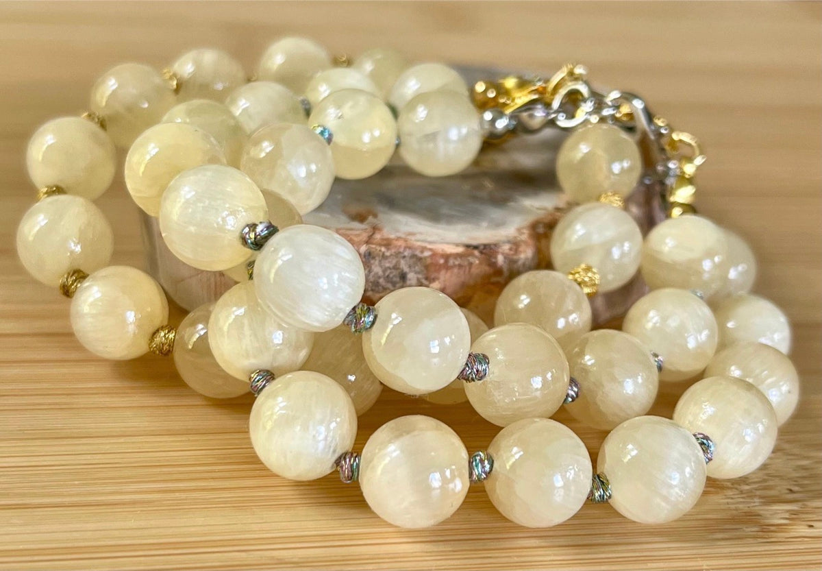 Silky yellow quartz bracelet. Chatoyant 10mm buttercream quartzite (AKA silk jade) hand-knotted bracelet with METALLIC string!
