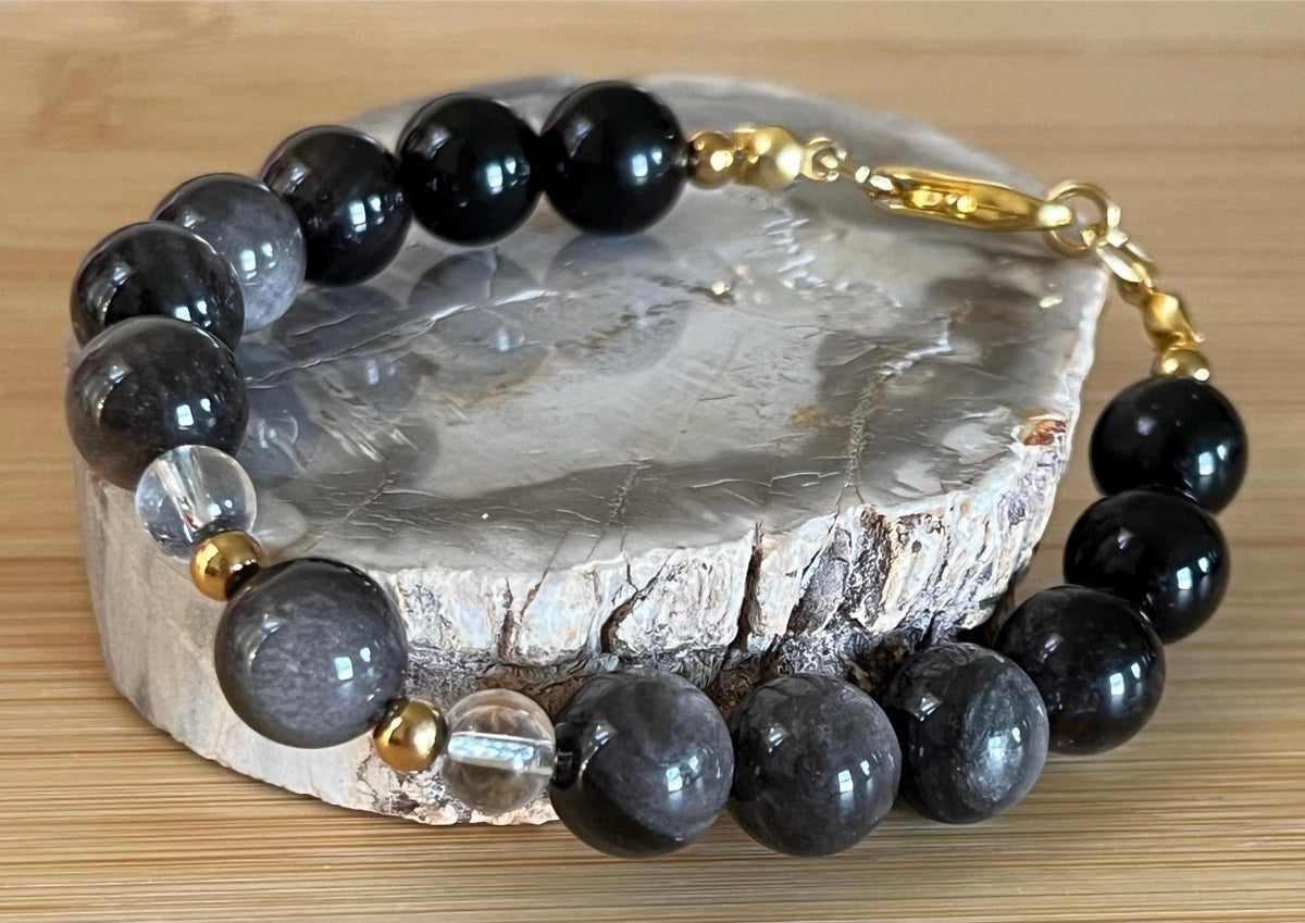 Silver sheen obsidian and clear quartz bracelet and earrings. Pair the “Silver Bells” bracelet and/or earrings with your little black party dress and be the Belle of the Ball!