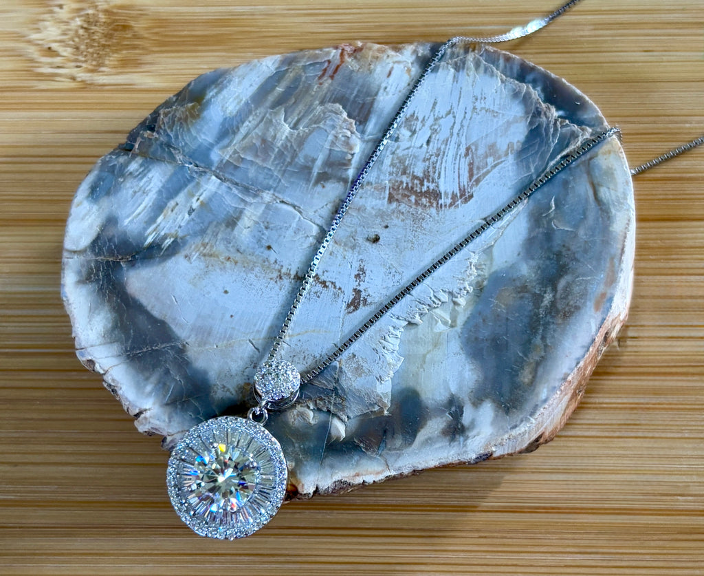 Moissanite necklace. The certified 2ct Moissanite “Sunburst” necklace with a 61 gemstone pendant plus more in the bail! Radiantly beautiful!