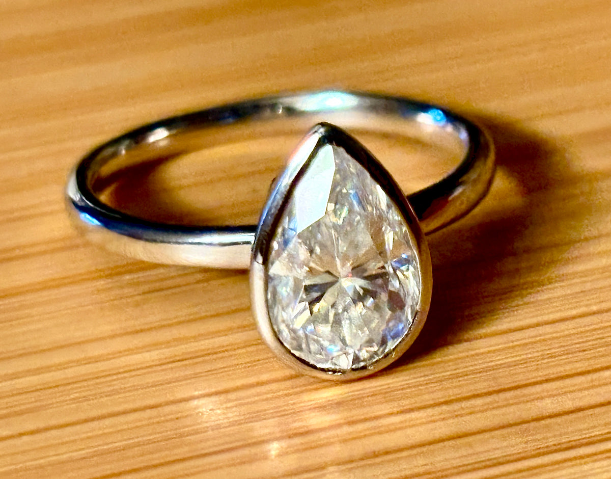 Moissanite ring. A certified 3ct pear in a hybrid basket + bezel of 925 sterling or 935 Argentium silver! A Hand Knotted Jewelry EXCLUSIVE!