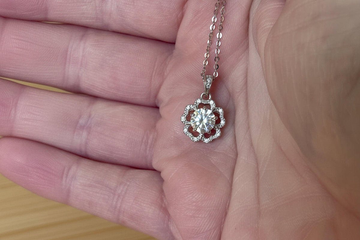 Moissanite necklace. A certified 1ct Moissanite hibiscus necklace with white zircon accents in solid sterling and white rhodium!