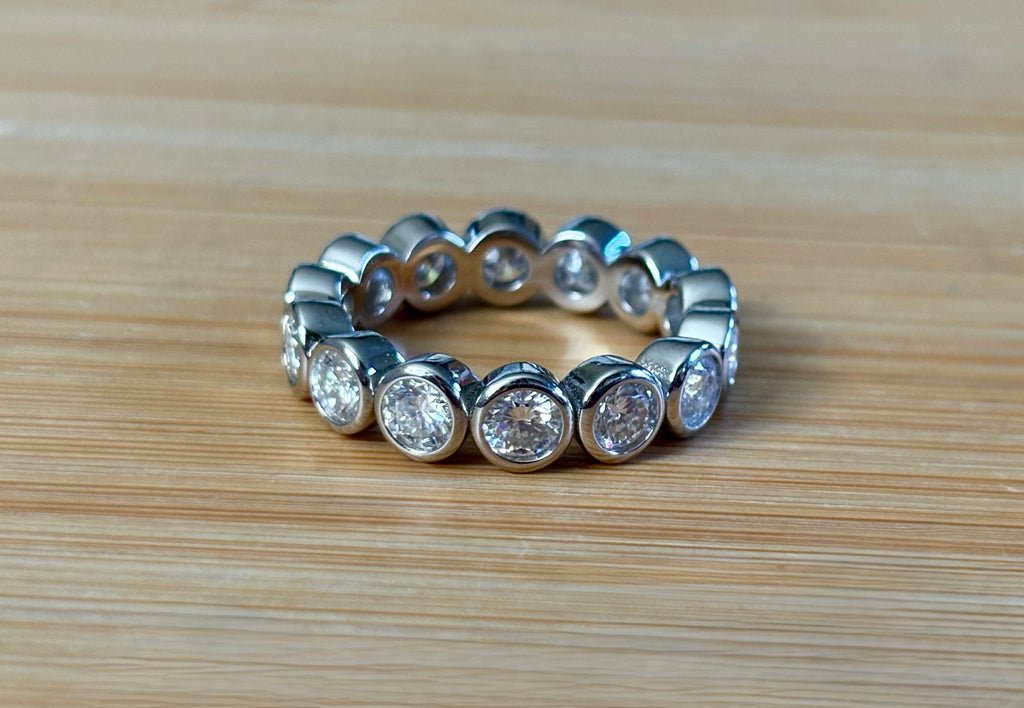 Moissanite ring. A certified, bezel-set eternity ring with 1/2ct round brilliant Moissanites set in a heavy, solid Argentium silver band!
