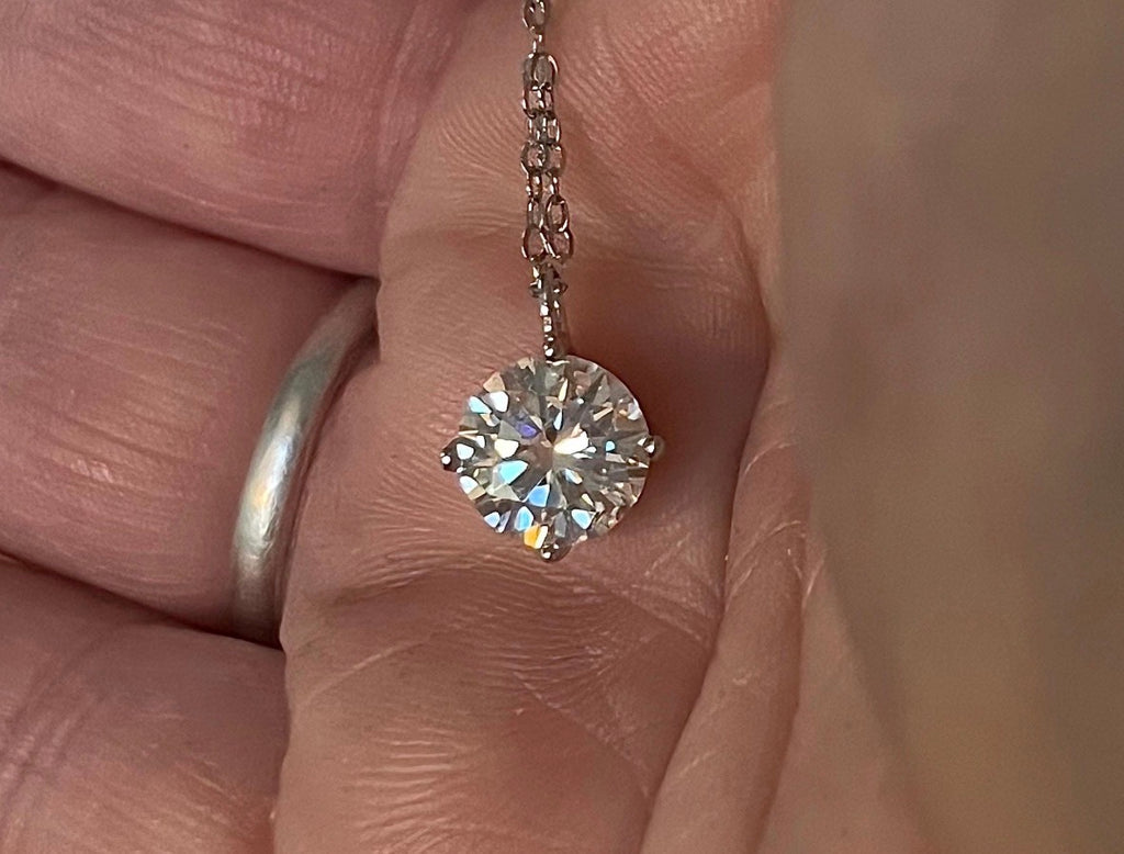 2ct Moissanite solitaire necklace. A 2ct “Floating Moissanite” in sterling silver creates the illusion of being suspended by nothing more than spider silk!