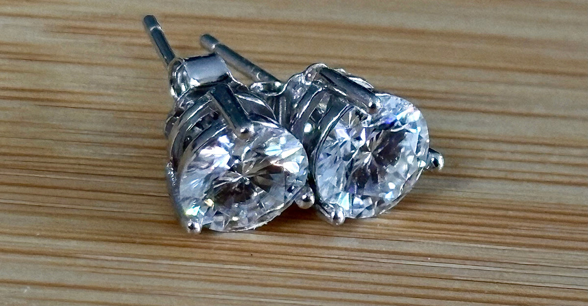 Moissanite earrings. A delicate certified 2cttw pair of 3-prong or 4-prong round brilliant Moissanites in 18k gold-embraced sterling silver baskets! Classic!