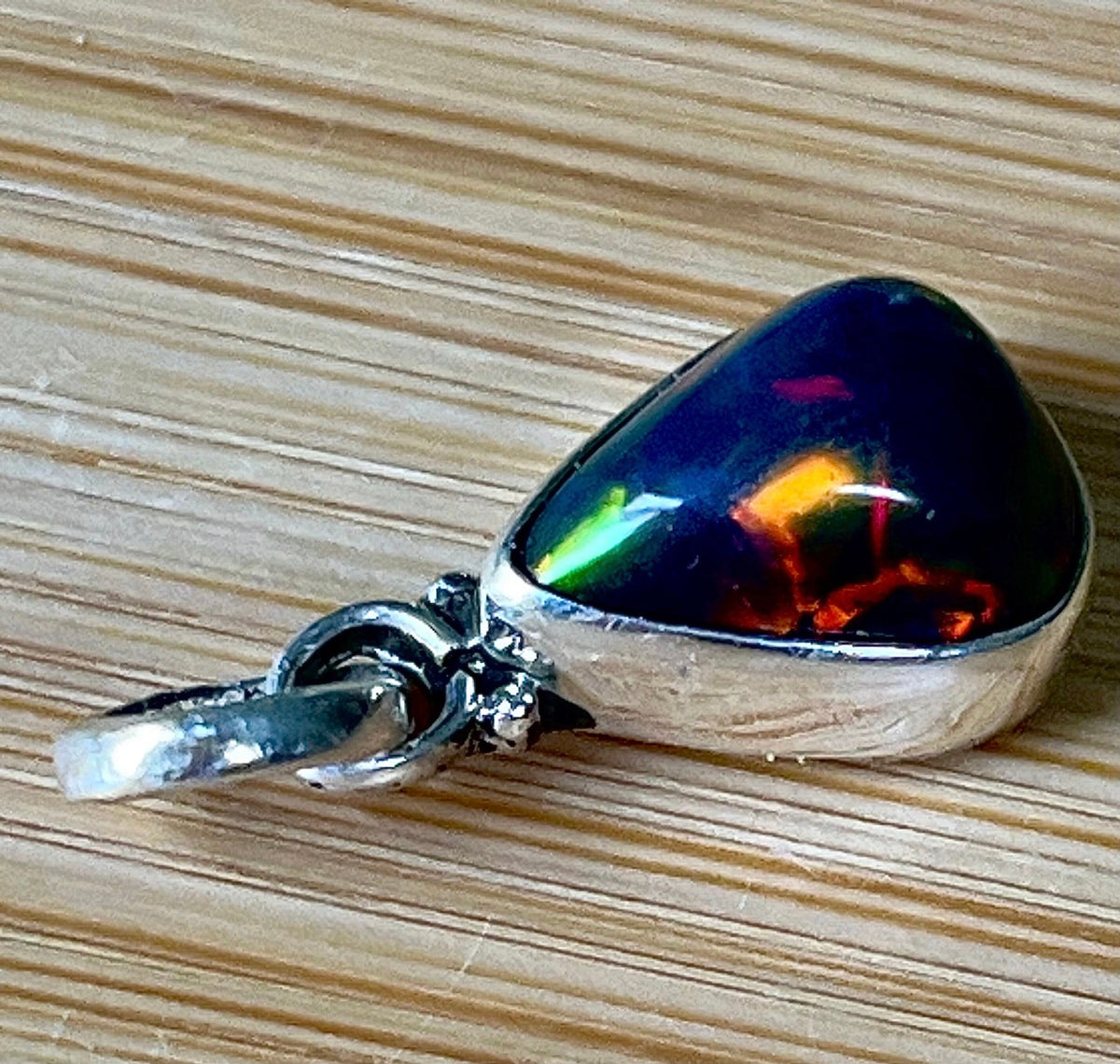 2.99ct Ethiopian opal pendant. AAA grade smoked opal cabochon pear in solid sterling silver. This flashy stone measures 9.6mm x 13mm!
