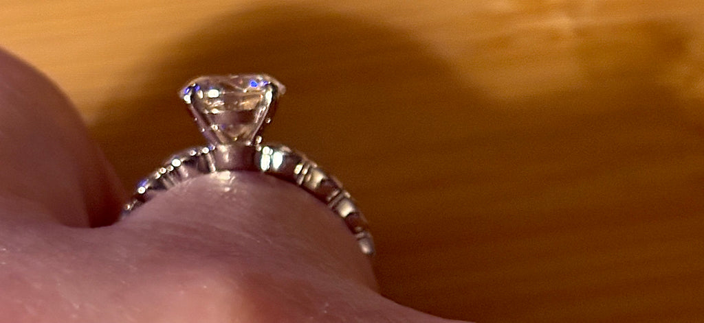 A 3.8cttw designer Moissanite ring with a certified 3ct center stone and 10-point bezel-set stones in sterling silver and 18k gold!