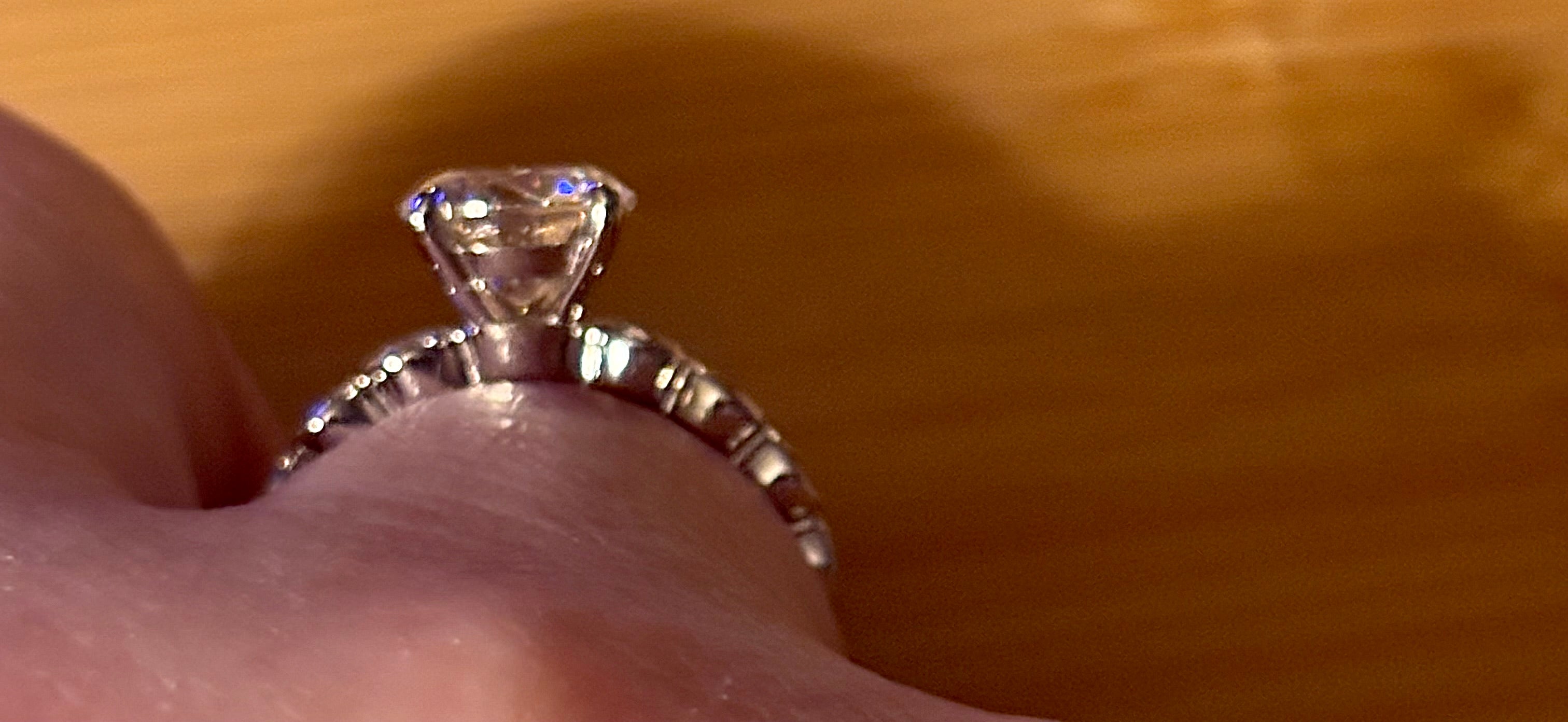 A 3.8cttw designer Moissanite ring with a certified 3ct center stone and 10-point bezel-set stones in sterling silver and 18k gold!