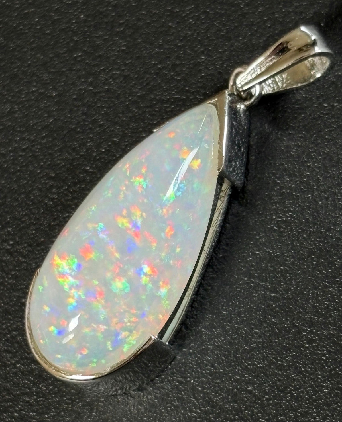 A GORGEOUS 11.05ct AAA+ grade Ethiopian pendant, an elongated pear-shaped cabochon with galaxy pattern fire and phenomenal play of color!
