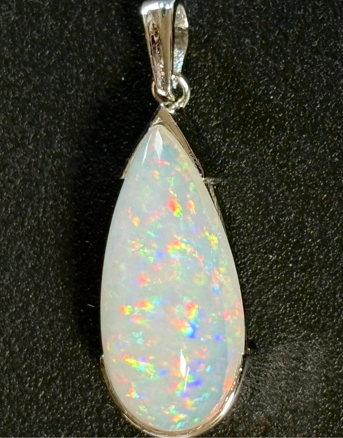 A GORGEOUS 11.05ct AAA+ grade Ethiopian pendant, an elongated pear-shaped cabochon with galaxy pattern fire and phenomenal play of color!
