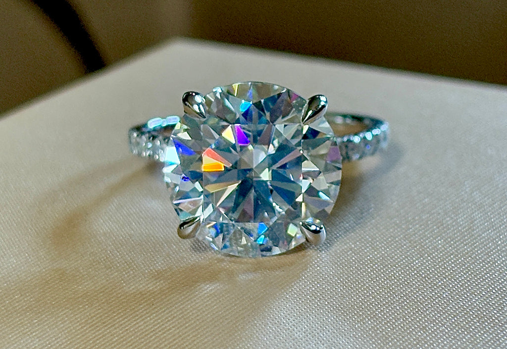 Moissanite solitaire. A glorious 10ct 8H8A Moissanite in a 4-prong mounting with a Moissanite “hidden halo” and shoulders, an 11.3cttw ring!