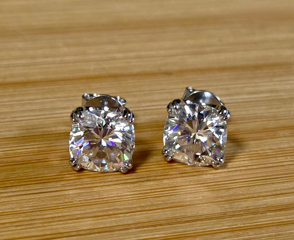 6ctw cushion-cut Moissanite studs in elegant sterling silver double-claw mountings! With brilliant faceting, these earrings are showstoppers!