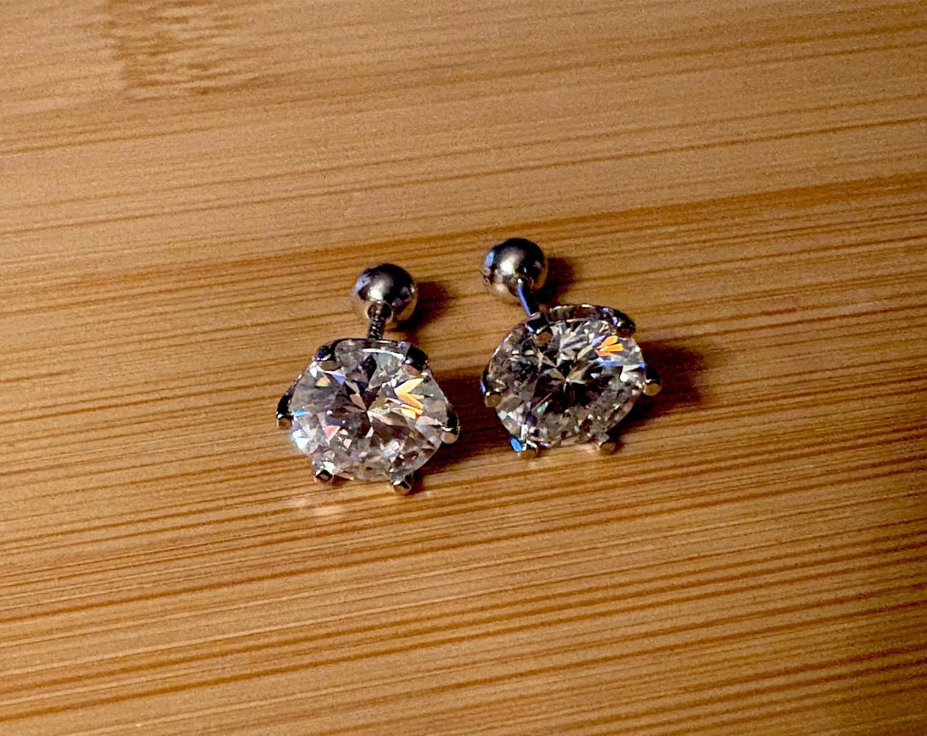 A certified pair of pretty, floral-inspired 2cttw or 4cttw Moissanite studs in poinsettia-shaped settings w/screwball backs OR 4cttw w/push backs!