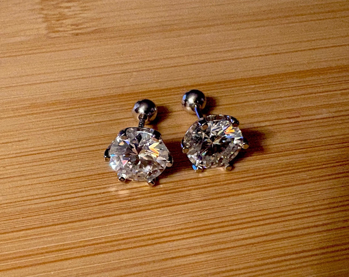 A certified pair of pretty, floral-inspired 2cttw or 4cttw Moissanite studs in poinsettia-shaped settings w/screwball backs OR 4cttw w/push backs!