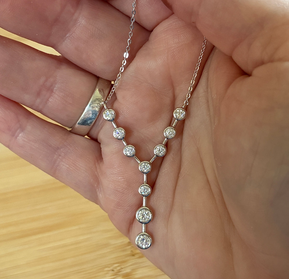 Moissanite neckpiece. A beautiful certified 1.4cttw Moissanite necklace featuring 10 round brilliants in a solid sterling bezel setting!