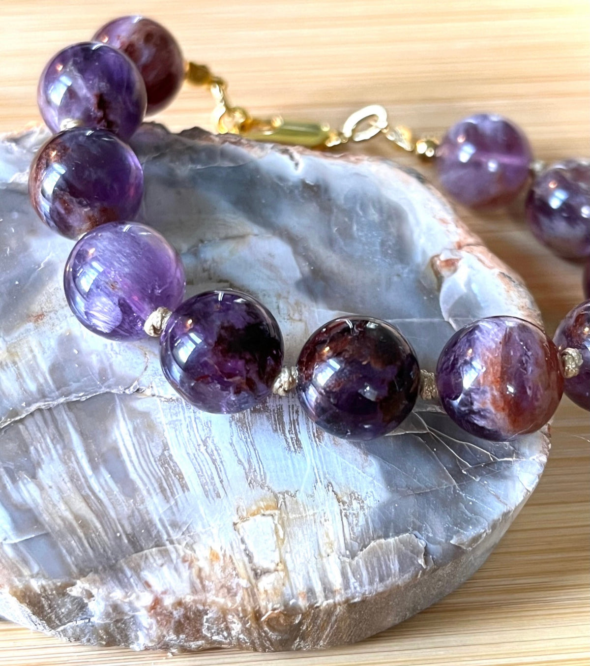 Super seven amethyst bracelet. AAA-grade 12mm “super seven”, mineral name cacoxenite amethyst, hand-knotted with silvery or golden hardware!
