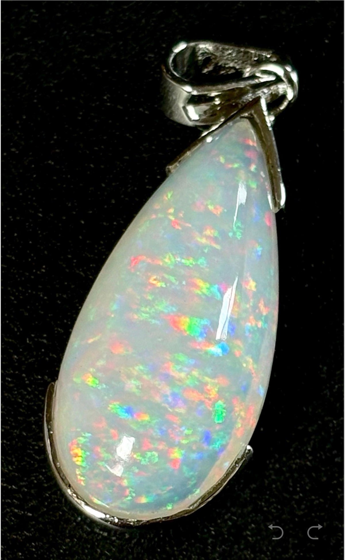 A GORGEOUS 11.05ct AAA+ grade Ethiopian pendant, an elongated pear-shaped cabochon with galaxy pattern fire and phenomenal play of color!