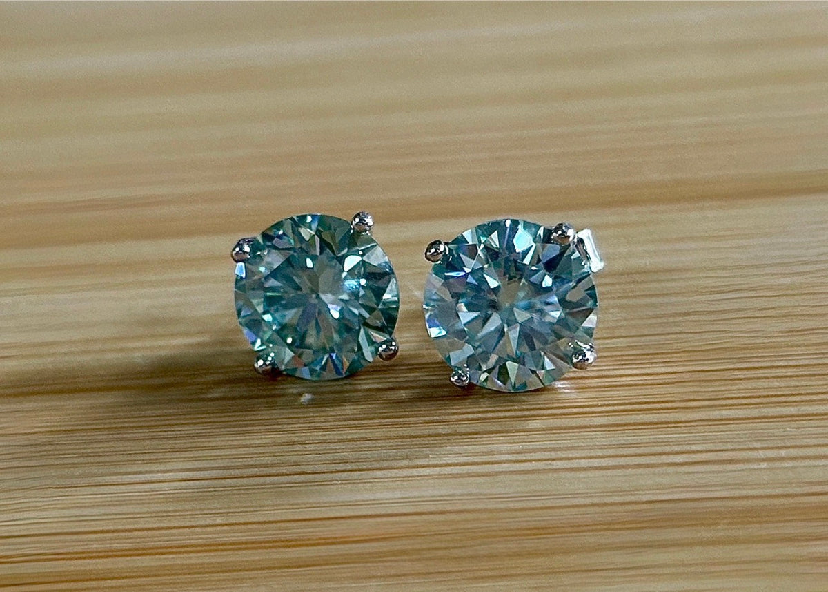 Moissanite earrings. A 6ctw certified pair of true icy baby blue Moissanite studs in sterling silver baskets with gleaming white rhodium!
