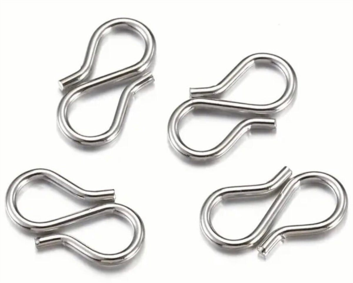Small sterling silver cross charms, stainless steel double lobster clasps and stainless steel S-hooks for various jewelry applications.