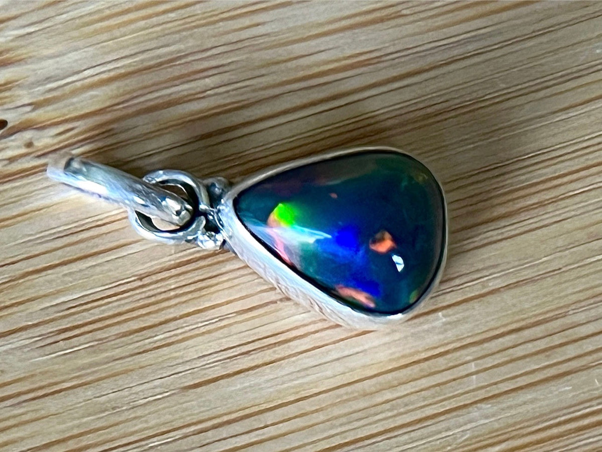 2.99ct Ethiopian opal pendant. AAA grade smoked opal cabochon pear in solid sterling silver. This flashy stone measures 9.6mm x 13mm!