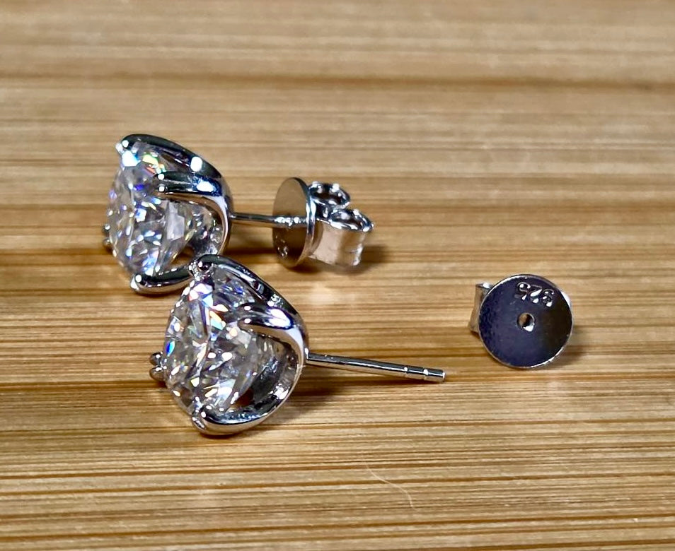6ctw cushion-cut Moissanite studs in elegant sterling silver double-claw mountings! With brilliant faceting, these earrings are showstoppers!