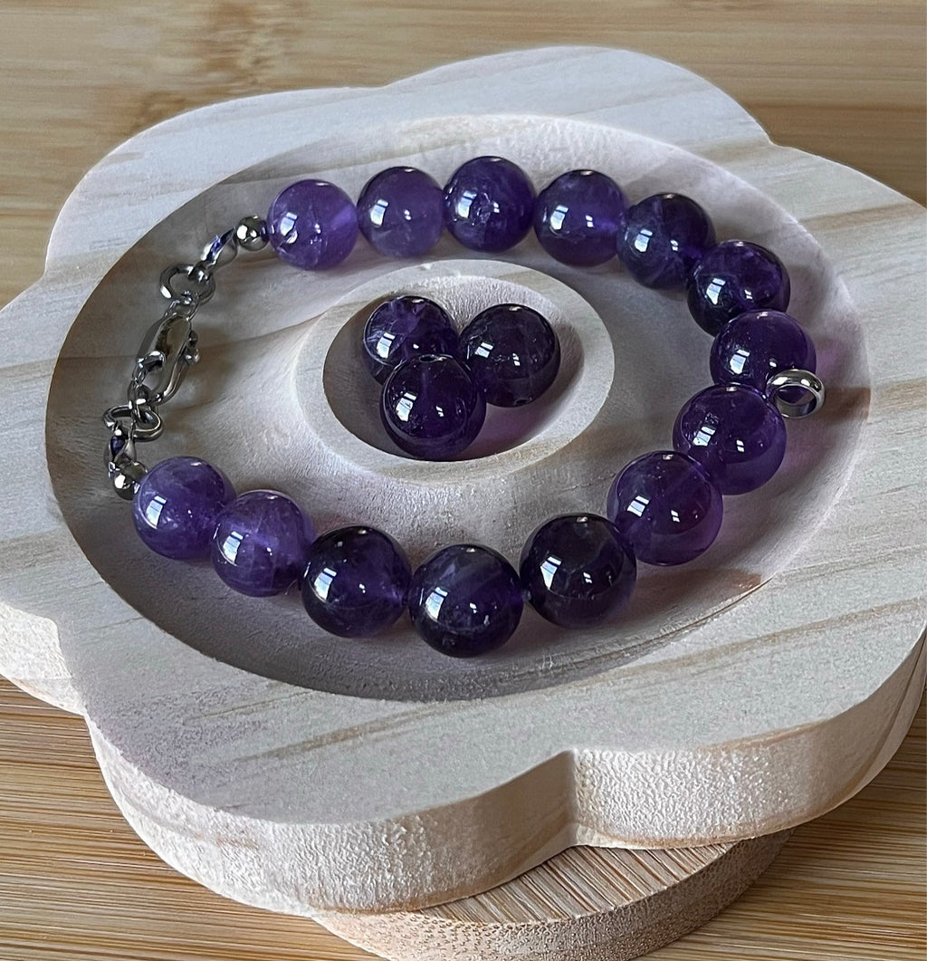 Amethyst bracelet. Natural and vibrant 10mm amethyst beads and stainless steel! The amethyst pendant in solid sterling silver is optional.