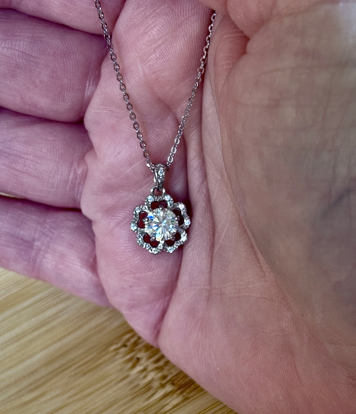 Moissanite necklace. A certified 1ct Moissanite hibiscus necklace with white zircon accents in solid sterling and white rhodium!