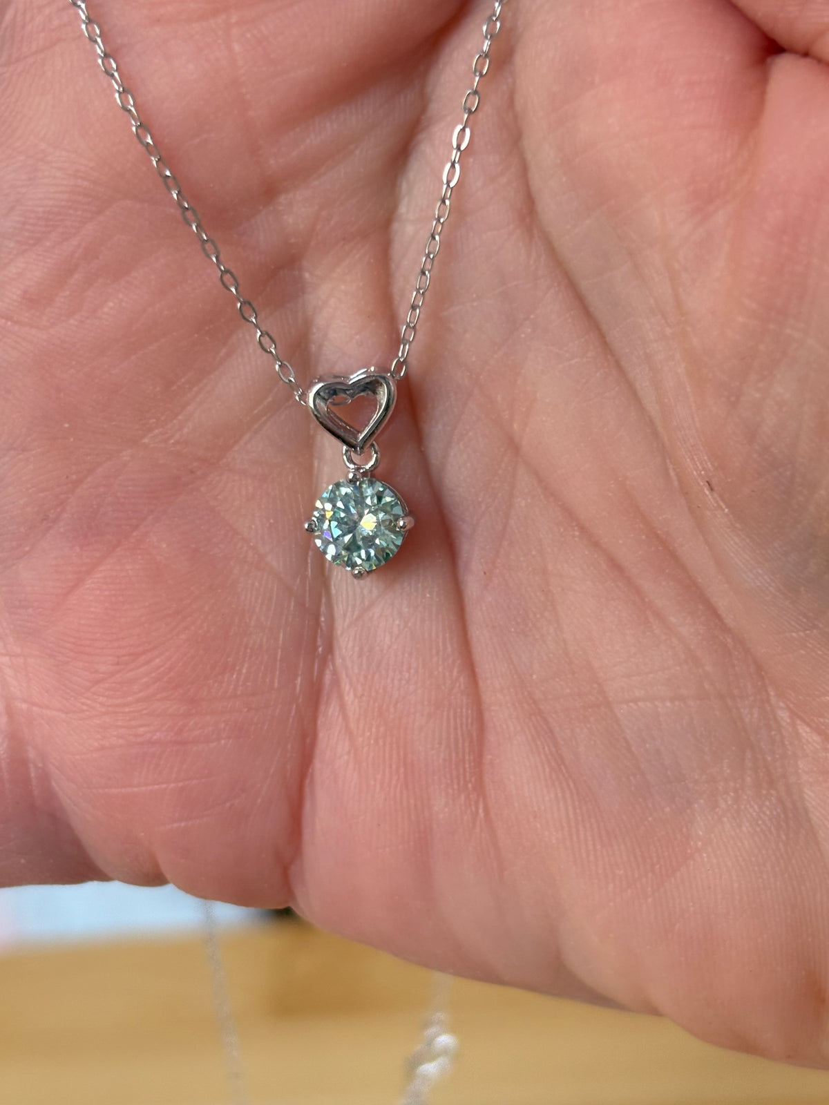 Moissanite necklace. A romantic heart-shaped pendant featuring a certified 1ct round WHITE or BLUE round brilliant Moissanite in sterling silver!