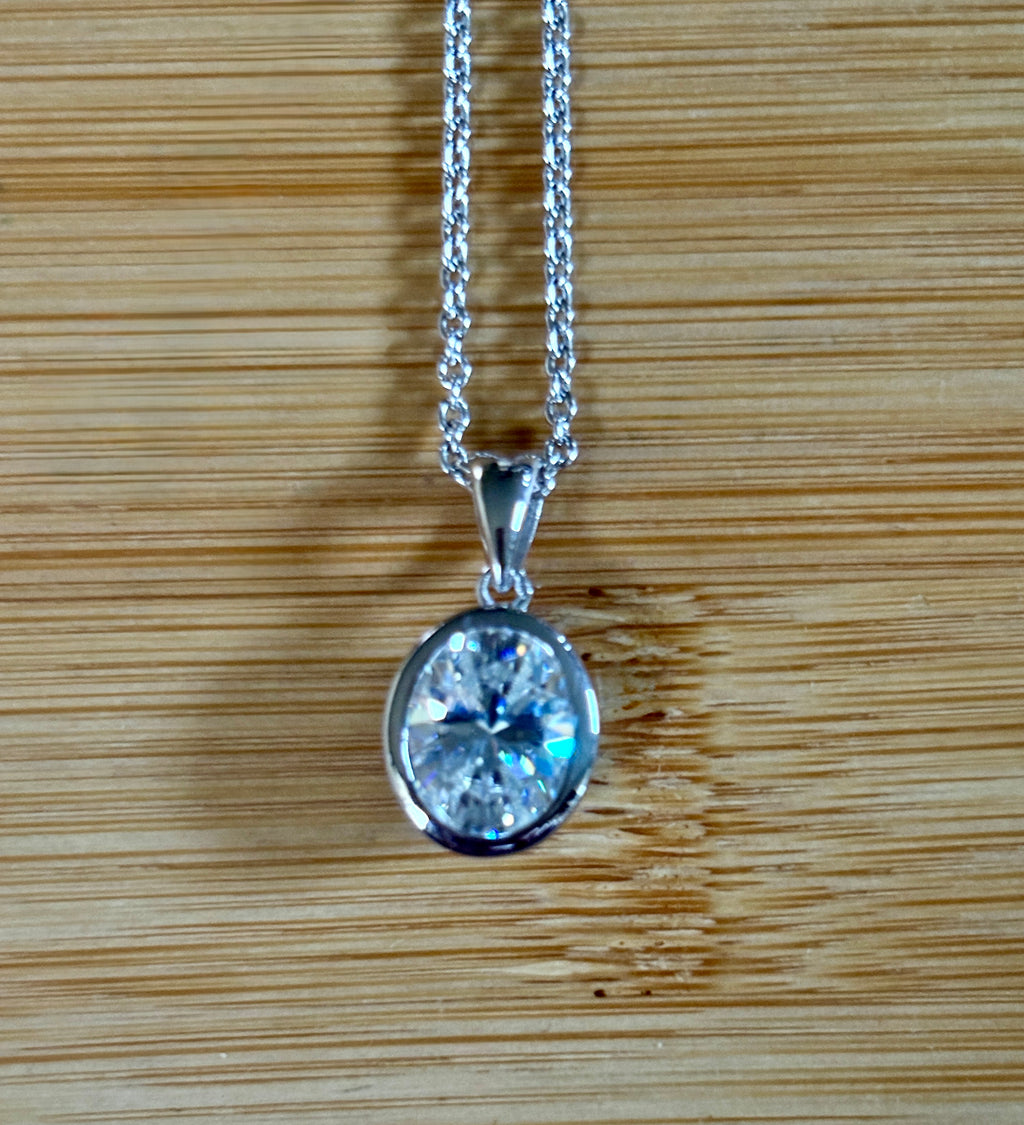 Moissanite solitaire necklace. A certified 5ct oval Moissanite in sterling silver and 18k!