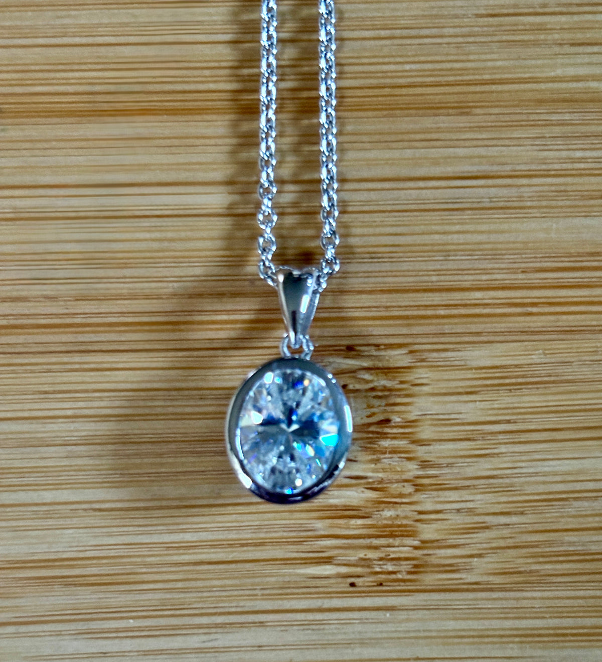 Moissanite solitaire necklace. A certified 5ct oval Moissanite in sterling silver and 18k!